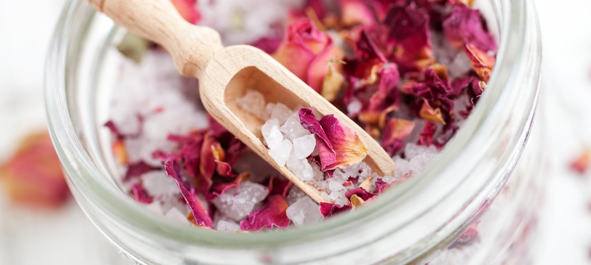 bath salts with roses and a wood scoop