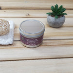 Chocolate Souffle Whipped Body Butter Tin next to plant