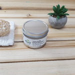 Cocoa Vanilla Body Butter Tin next to plant