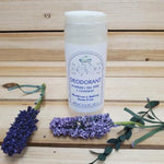 Natural Deodorant Rosemary, Tea Tree and Lavender against wood background next to lavender
