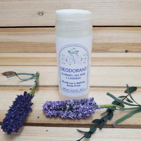 Natural Deodorant Rosemary, Tea Tree and Lavender against wood background next to lavender