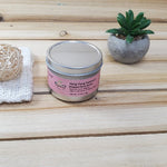 Ylang Ylang Patchouli Body Butter Tin next to plant