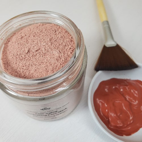Anti-Aging Hydrating Face Mask next to fan brush and hydrated in small white dish