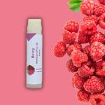 Berry lip balm with raspberry background