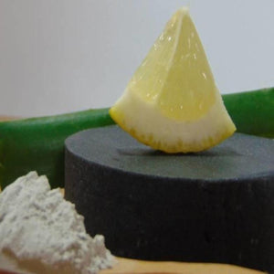 Lemon Wedge on top of Activated Charcoal Handmade Natural Soap Bar