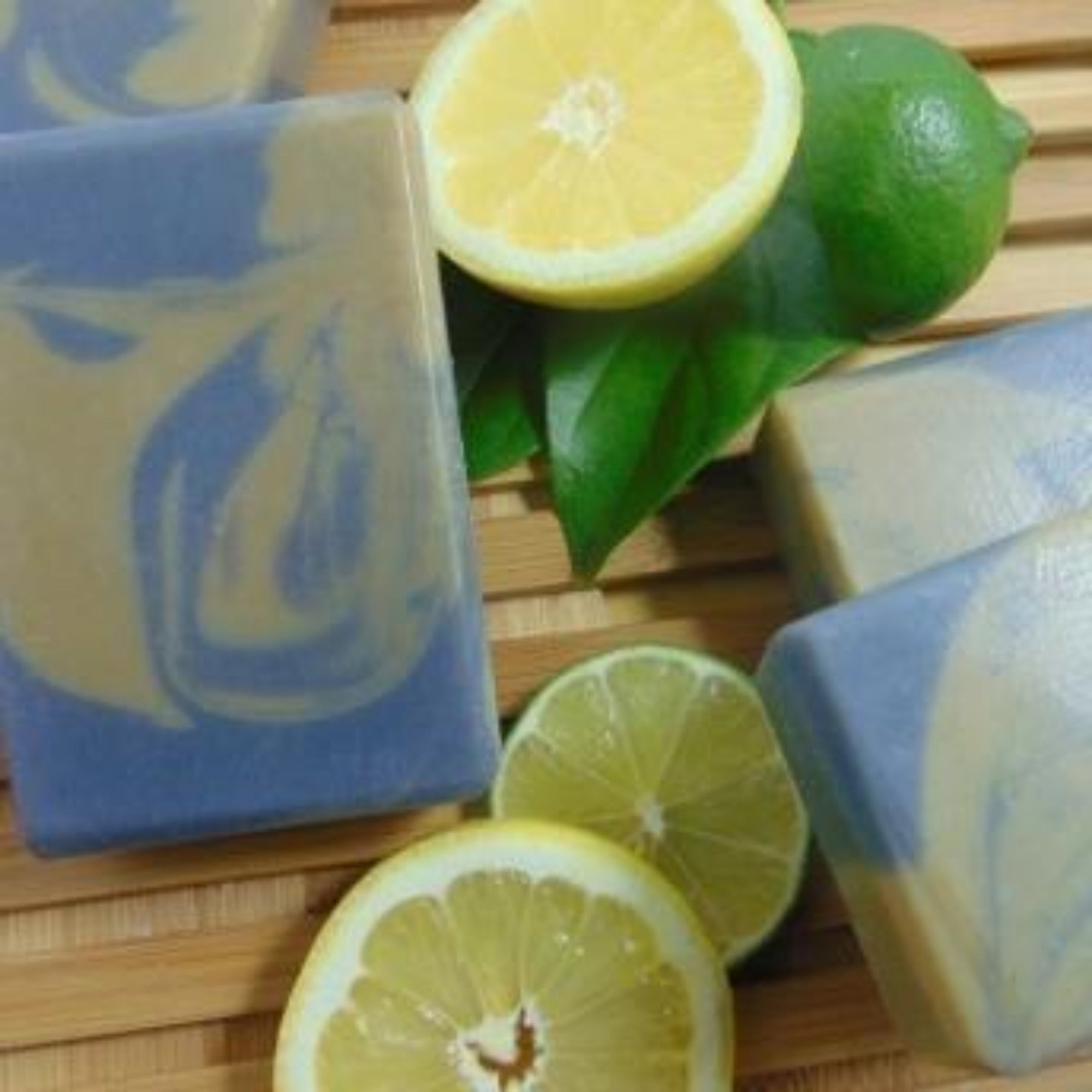 Activated Charcoal  & Clay Handmade Natural Soap Bar styled with fresh lemons and a lime