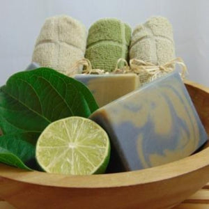Activated Charcoal  & Clay Handmade Natural Soap Bar in wood bowl with towels and a lime