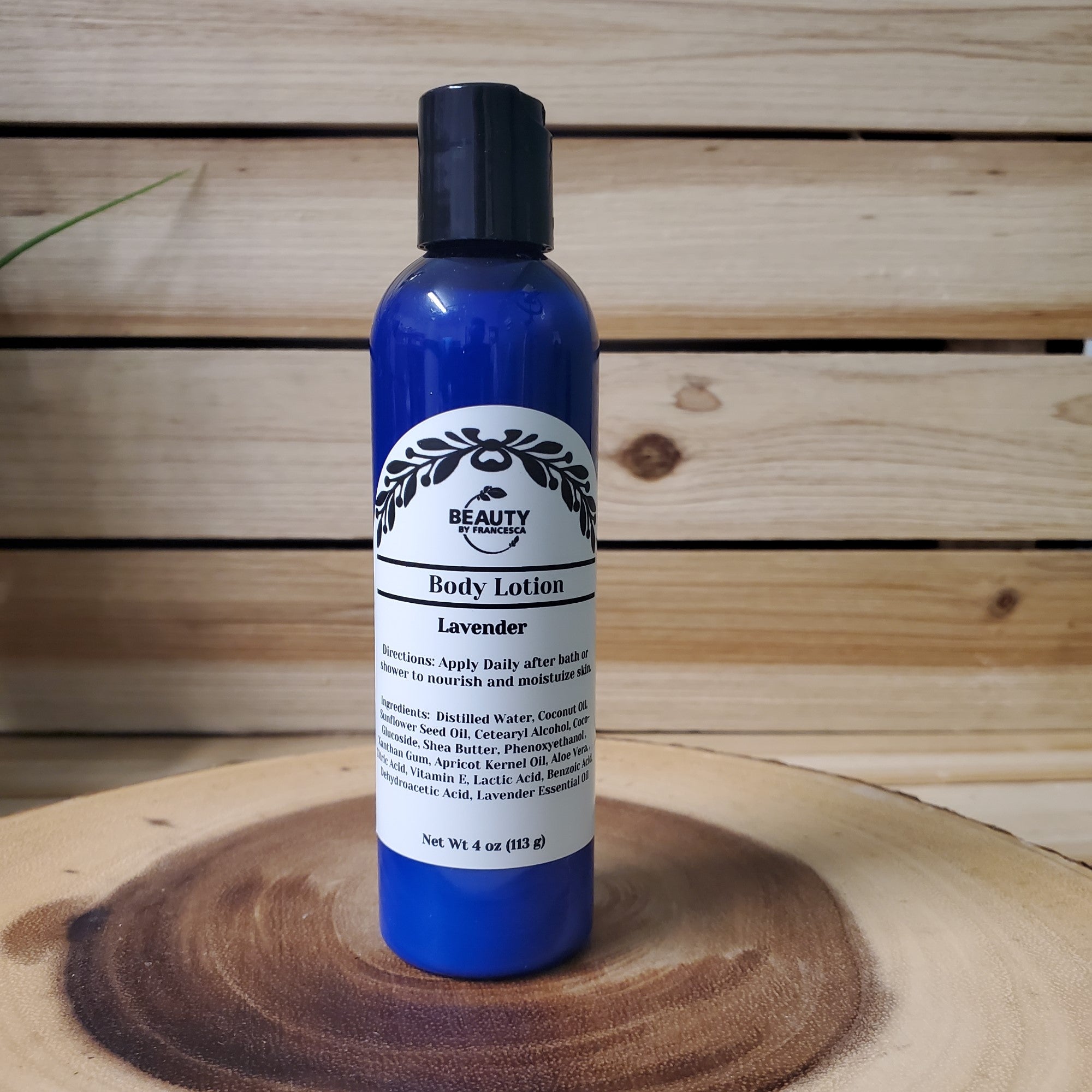 lavender body lotion on a wood table