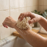 Natural ramie body pouf shown in use