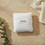 White soaping sponge pocket on a neutral spa-inspired surface