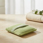Green soaping sponge pocket in a spa setting