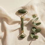 Double-ended jade facial roller in a spa setting