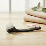 Black facial cleansing brush, side view