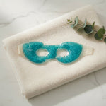 Blue gel bead eye mask on a towel