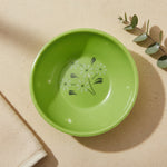Green facial mask mixing bowl with a white floral design inside