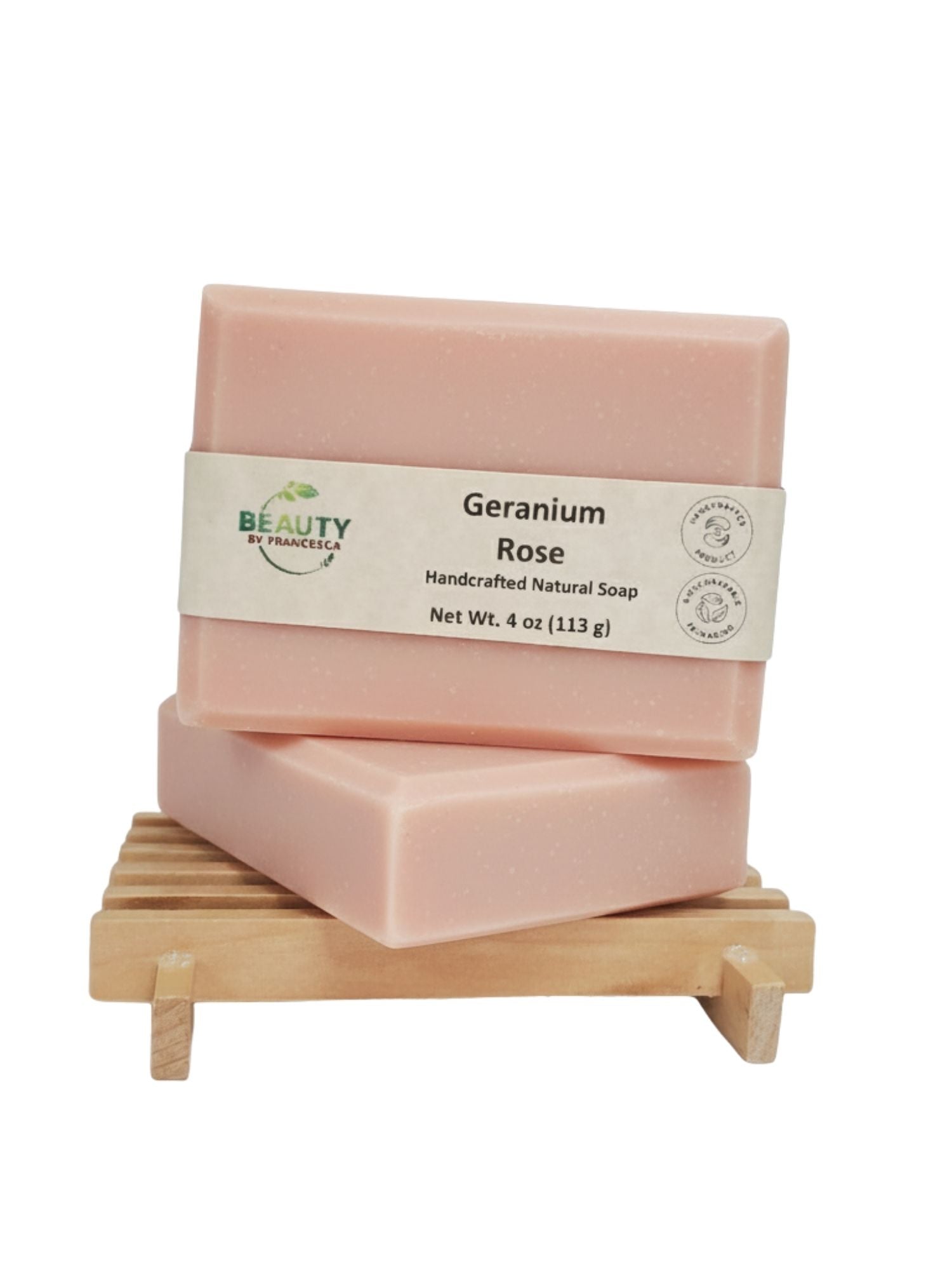 Two bars of Geranium Rose soap on a wooden stand with a white background