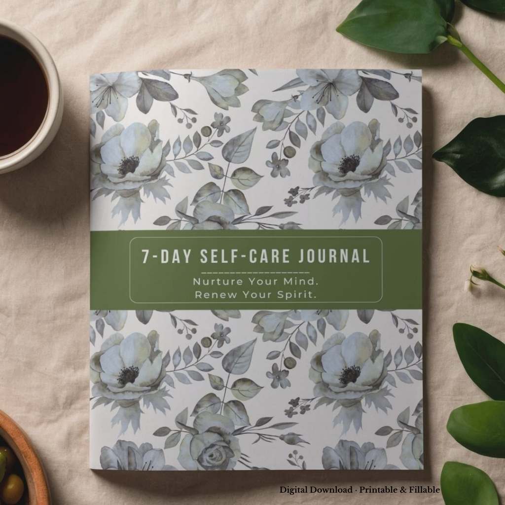 7-Day Self-Care Journal with floral design on a beige surface with leaves and a cup of coffee.