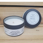 Angel's Breath Candle in a black tin against a wood background