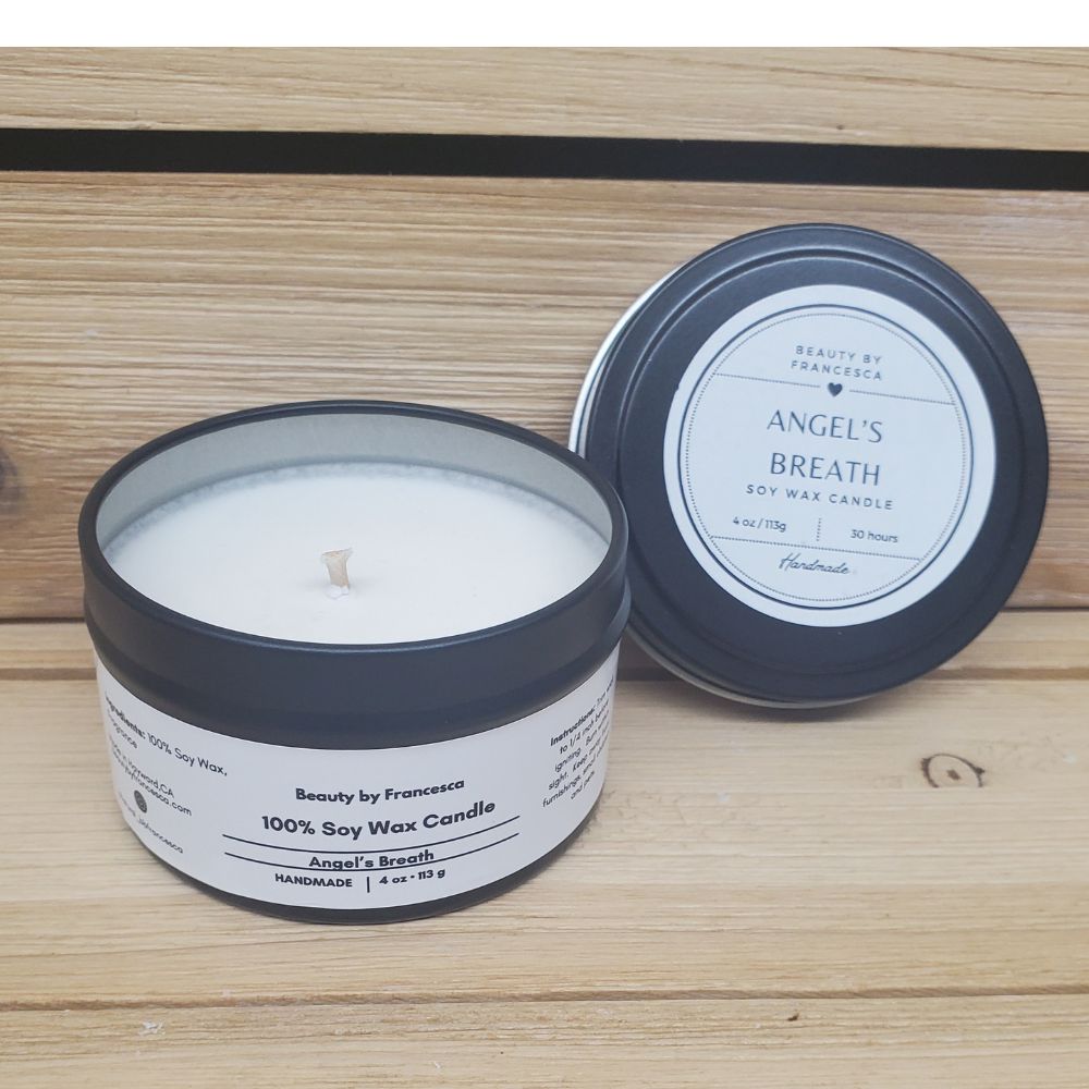 Angel's Breath Candle in a black tin against a wood background
