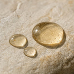 oil droplets on beige stone of Fragrance Free Beard Oil