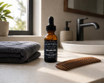 all natural beard oil - ocean scent - on sink counter next to towel and wood comb