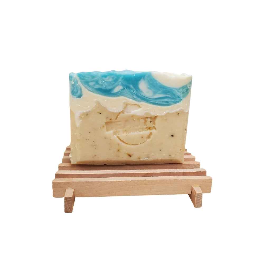 Coastal Spa handmade soap inspired by sandy beaches and ocean waves on a wooden soap dish