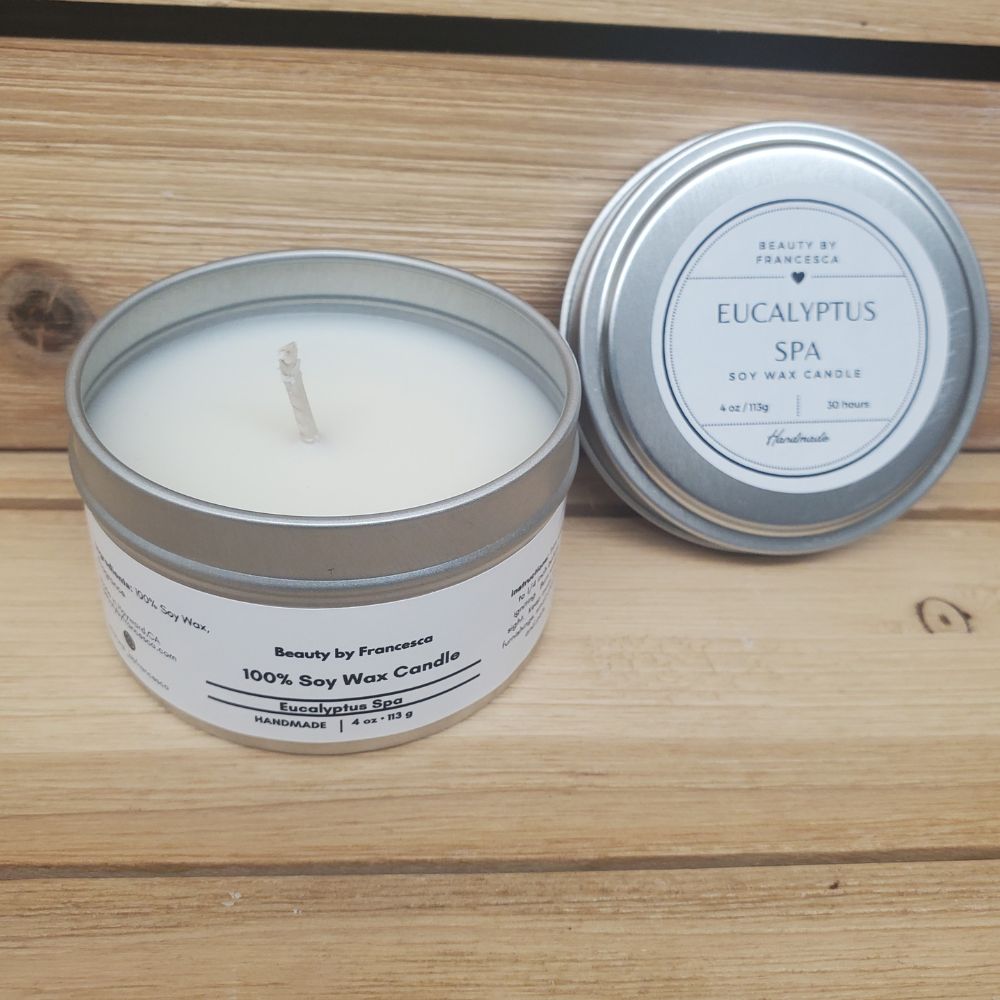 Eucalyptus Spa Candle in a silver tin  against a wood background
