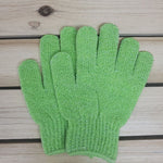 Set of Green scrubbing gloves on a wooden surface