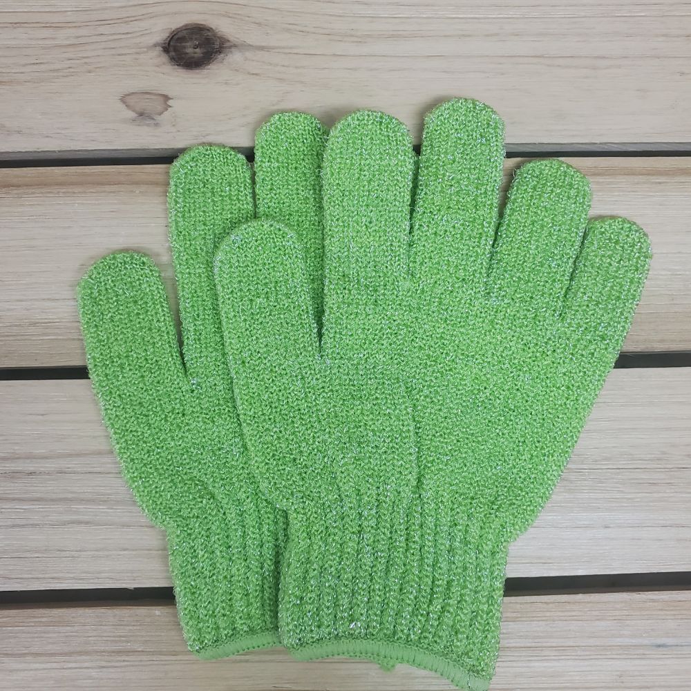 Set of Green scrubbing gloves on a wooden surface