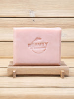 Pink geranium rose soap bar with 'Beauty by Francesca' branding on a wooden stand.