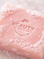Pink geranium rose soap bar with bubbles and 'Beauty by Francesca' branding on a white background