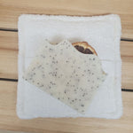 Soaping Sponge Pocket  with lemon poppy seed soap against a wood background