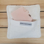 Soaping Sponge Pocket  with pretty in pink soap against a wood background