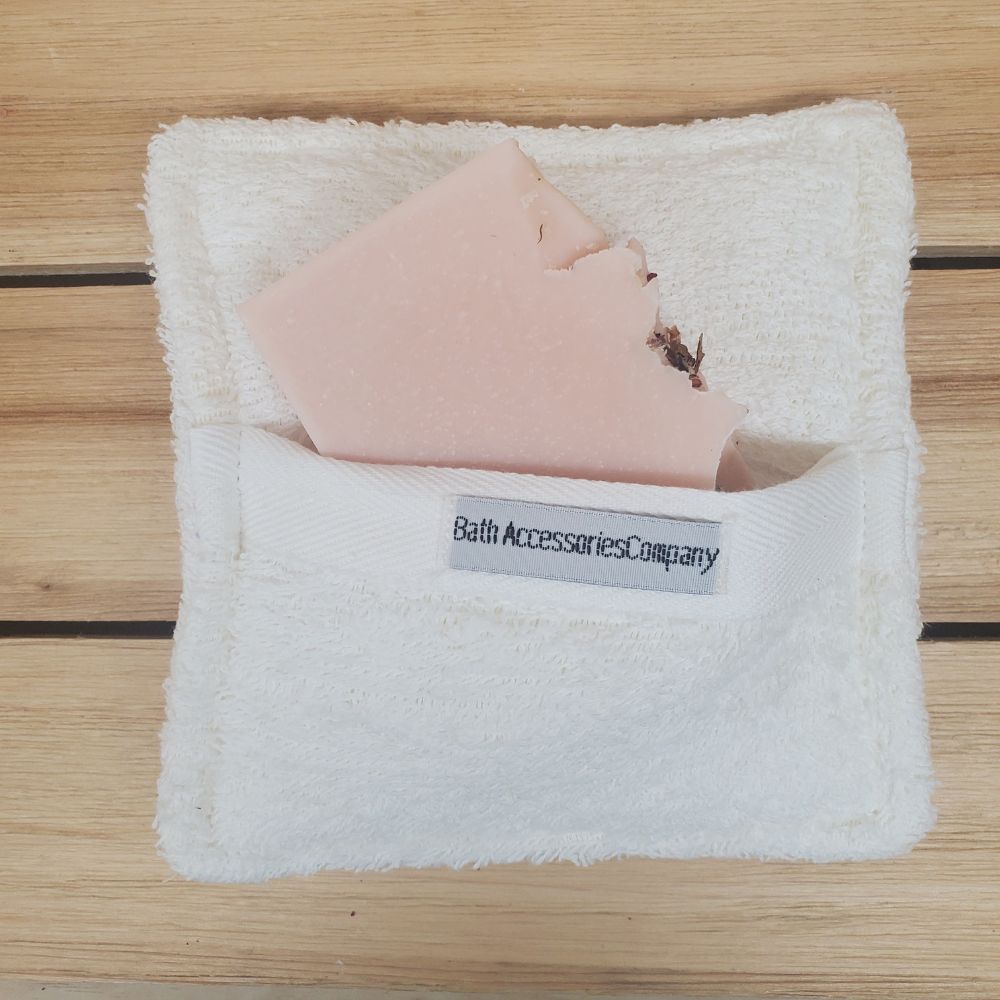 Soaping Sponge Pocket  with pretty in pink soap against a wood background