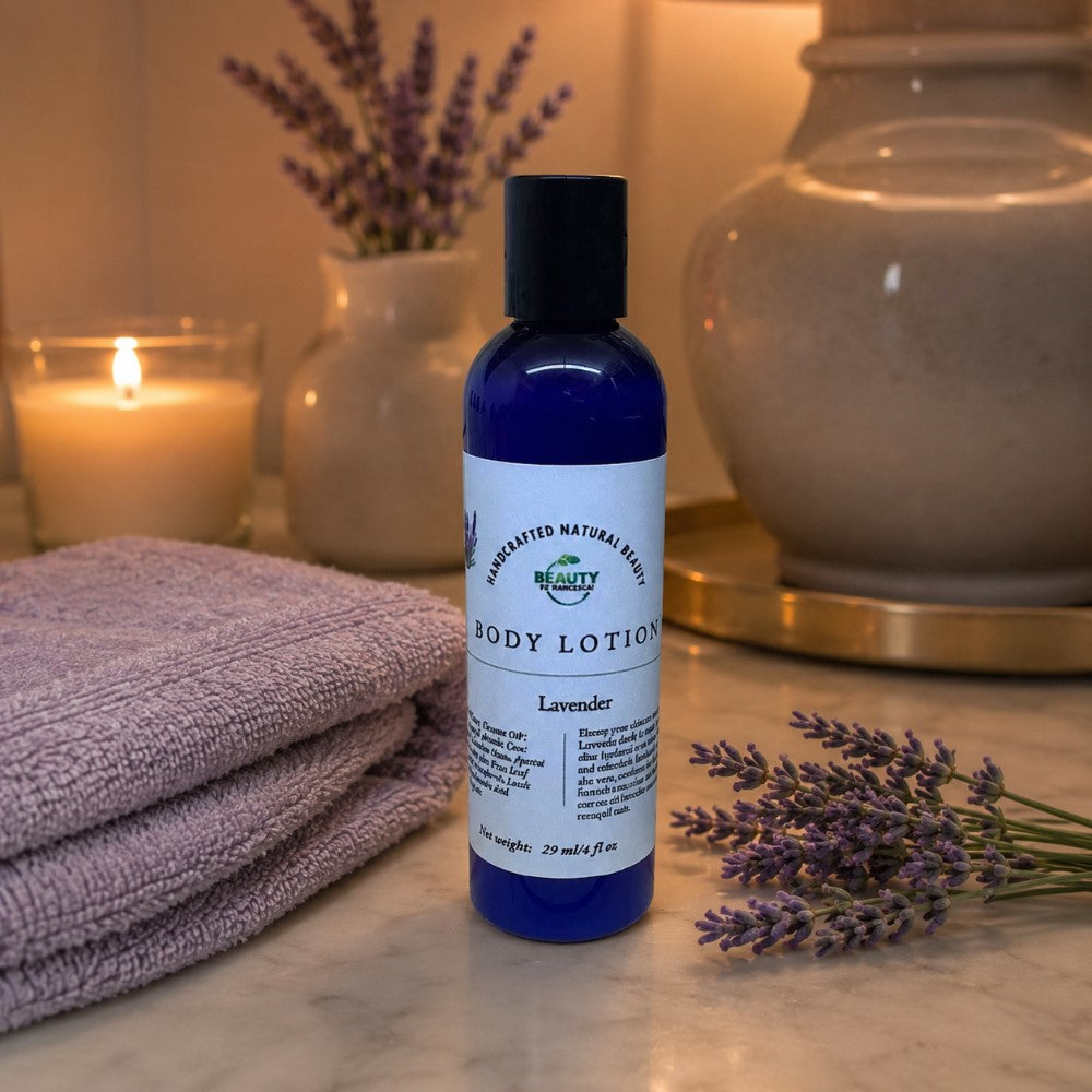 Lavender Body Lotion next to sprigs of fresh lavender, a lavender towel, and a lit candle in the background