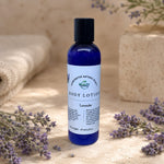 Lavender Body Lotion next to sprigs of fresh lavender