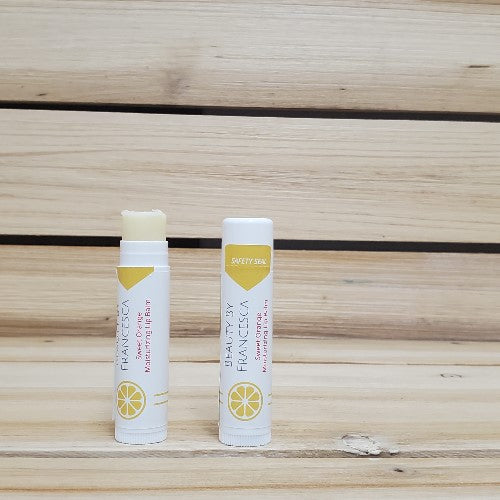 sweet orange lip balm displayed with one open top and one closed top