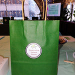 Green Beauty by Francesca bag on a table in an indoor setting