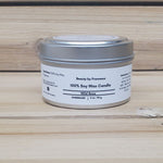 Wild Rose Soy Candle in a closed tin  on a wooden surface