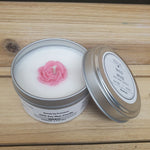 Wild Rose Soy Candle in a tin with a on a wooden surface