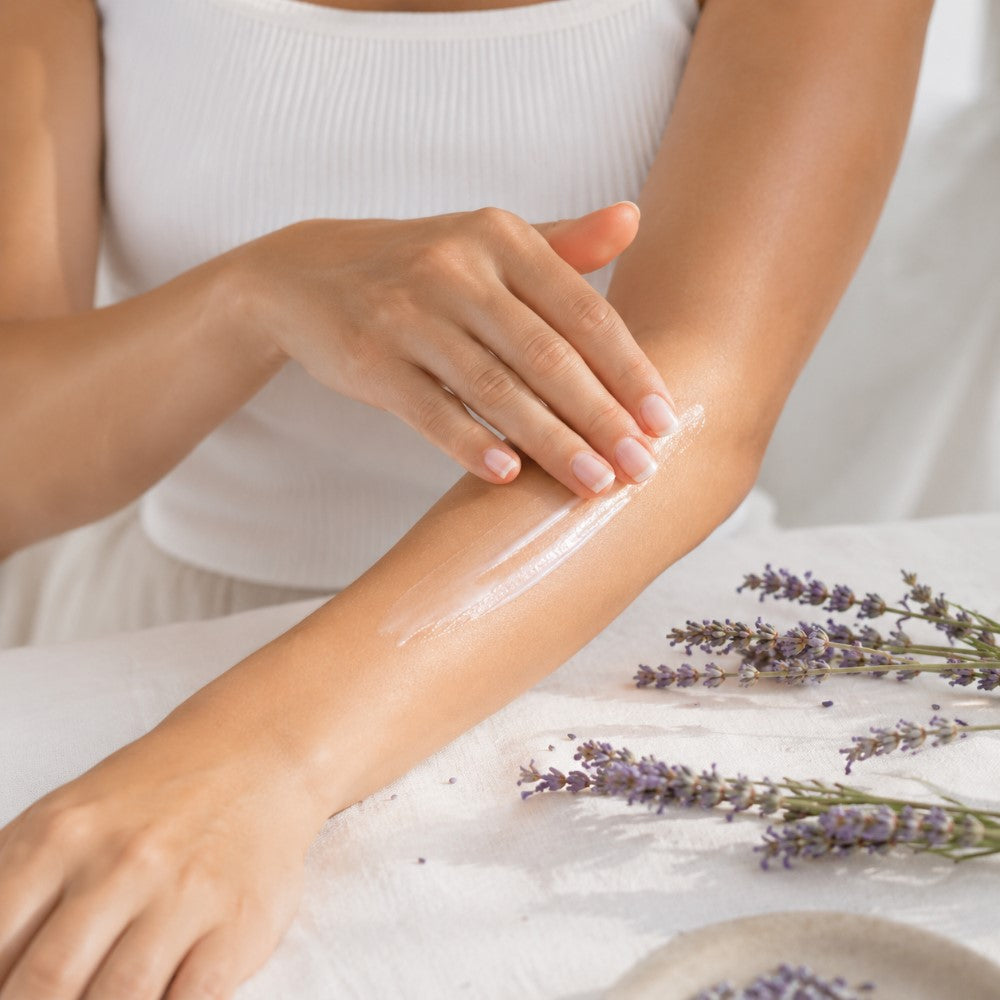 Woman applying Lavender Body Lotion to forearm