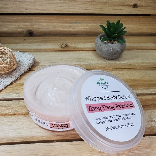 Ylang Ylang Patchouli  Whipped Body Butter Open Lid Next to Plant