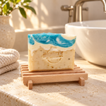 Coastal Spa handmade soap beside a bathroom sink in warm natural light