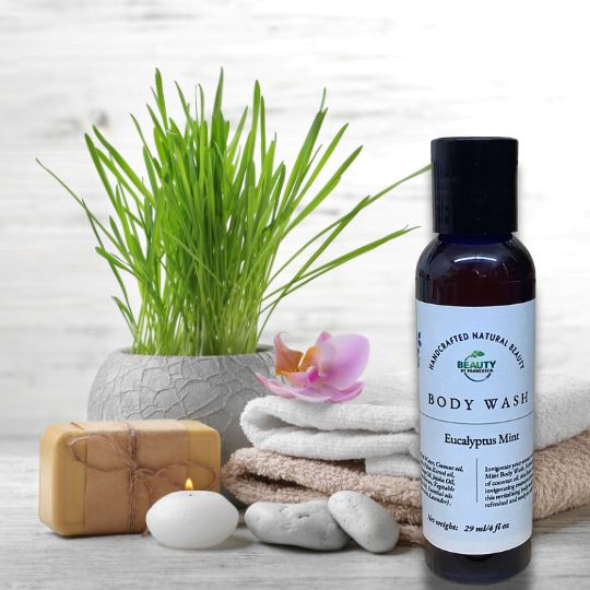 Eucalyptus Mint Body Wash in from of towels, plant, candle and soap