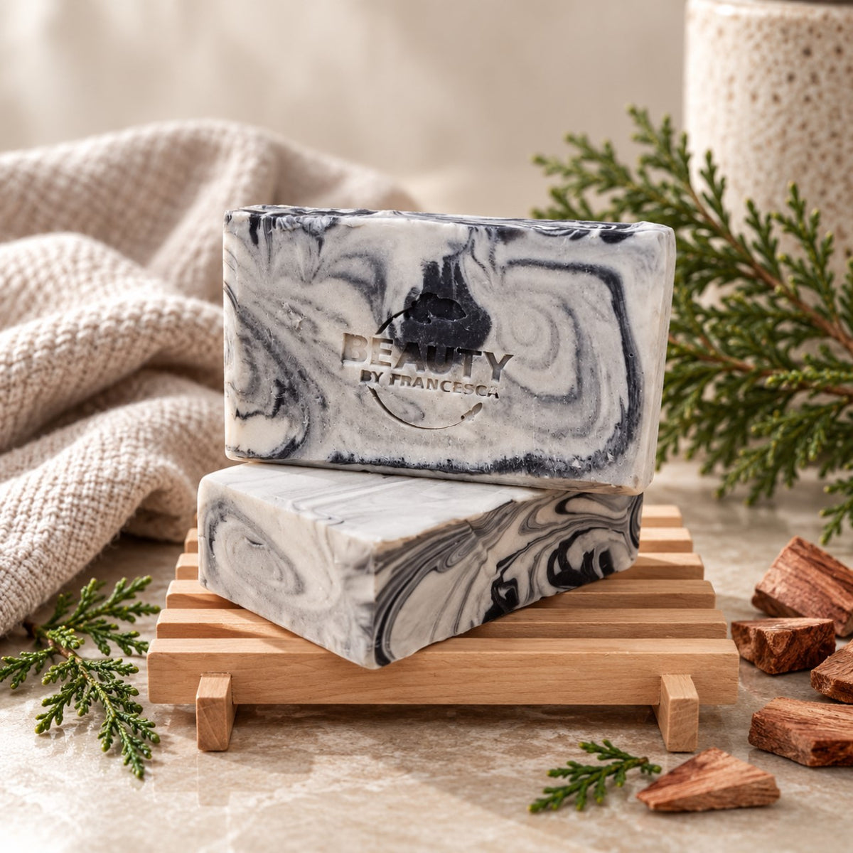 Two bars of Fire and Ice handmade soap on a wooden soap dish with cedarwood accents