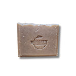 Bar of honey oatmeal chai soap with a logo on a white background