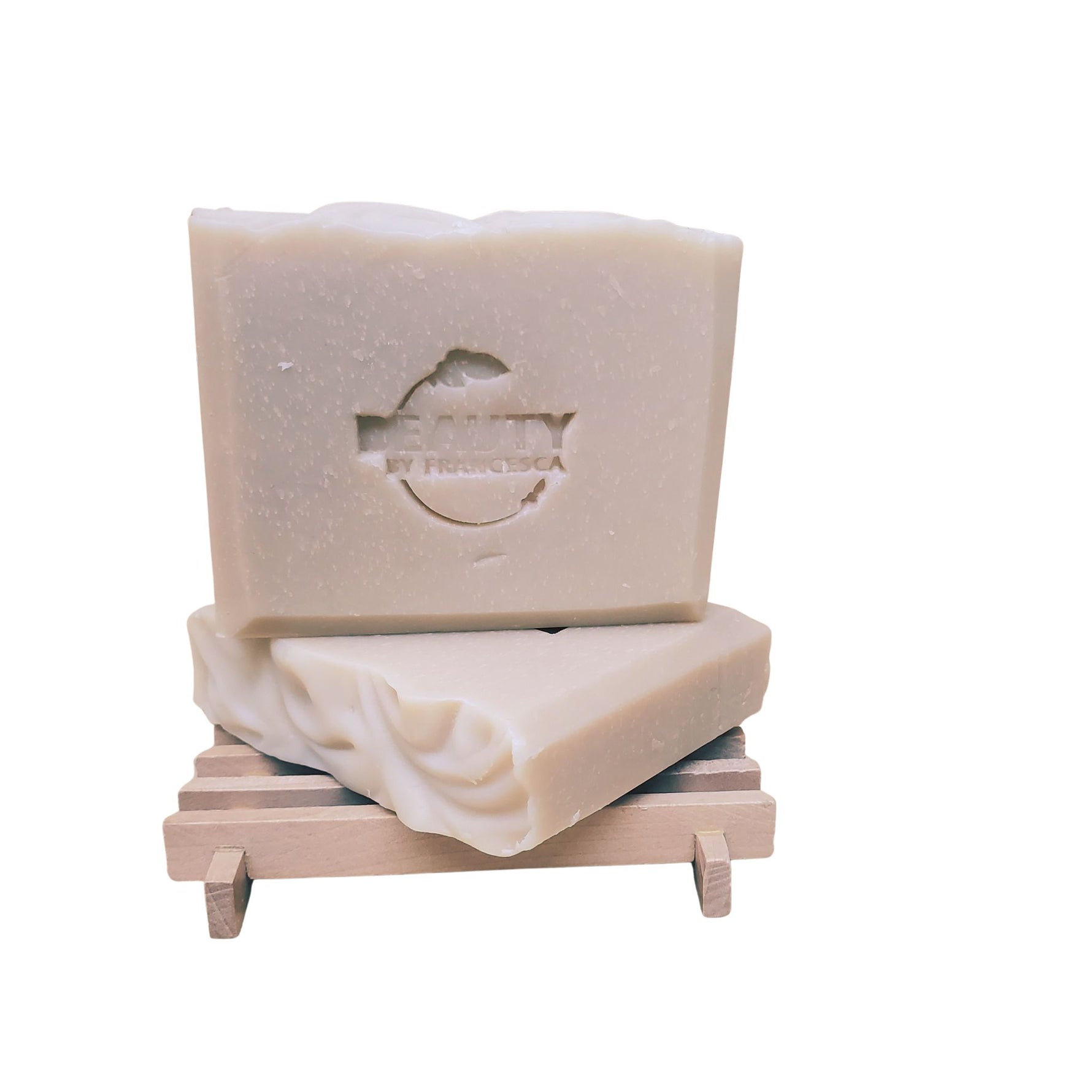 two bars of lavender orange soap on a soap dish white background