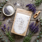 luscious lavender bath salt, 16 oz, flay lay with lavender, a wood scoop and a bowl of lavender and sea salt