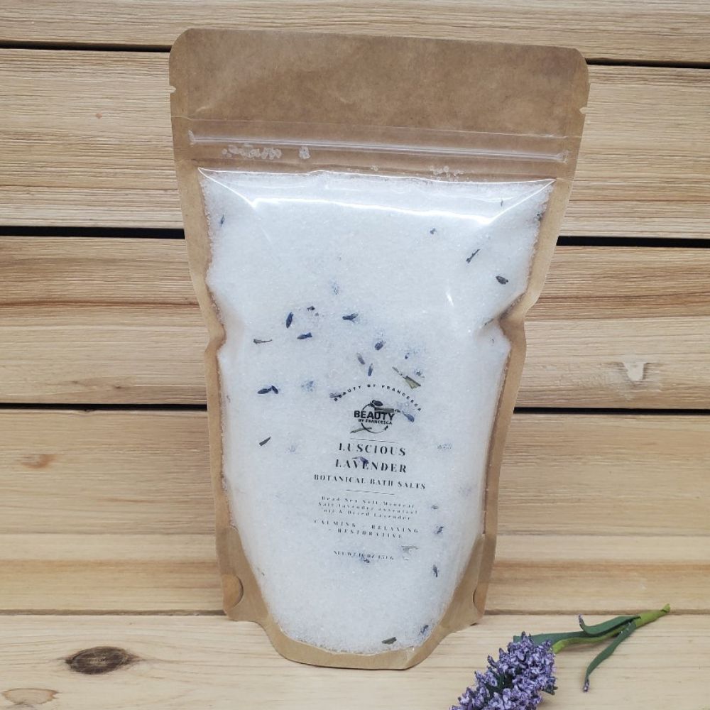 Luscious Lavender Bath Salts next to a lavender flower