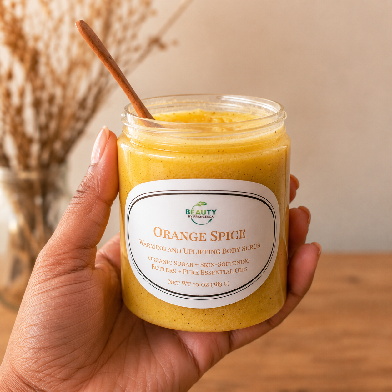 hand holding orange spice body scrub 